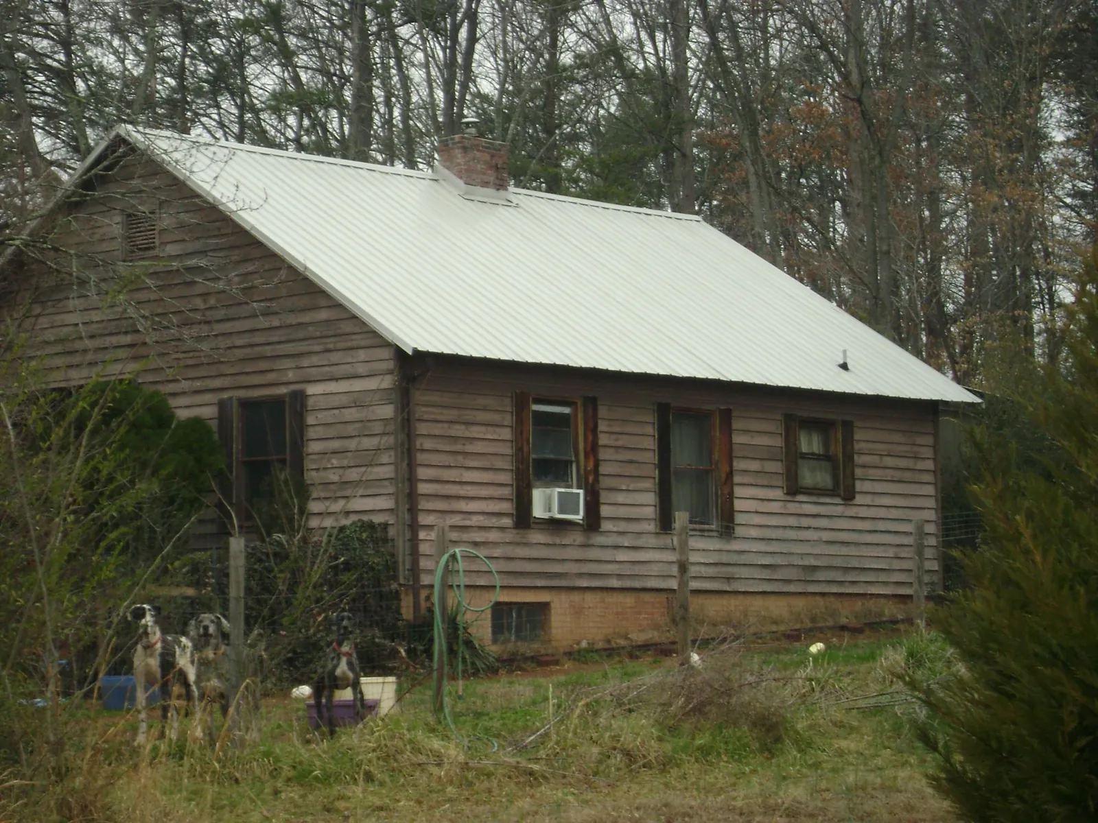 White metal roof on an old wood sided farmhouse, from a Metal Roof Installation job in Waterloo